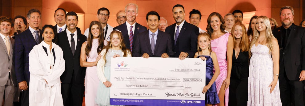helping kids fight cancer foundation showing their big check from hyundai hope on wheels - Hyundai of 110 in Farmingdale NY